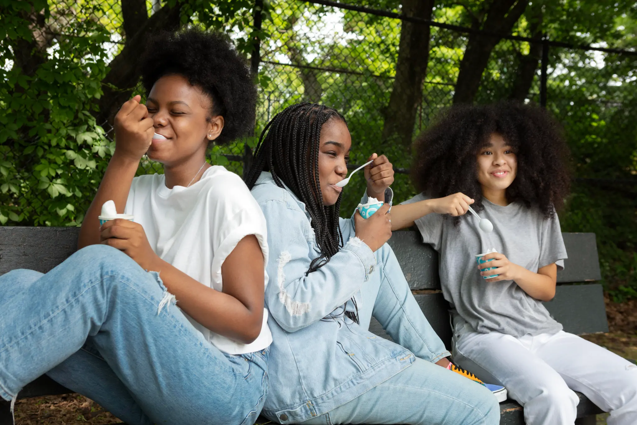 Girls together outdoors in a friendly moment.